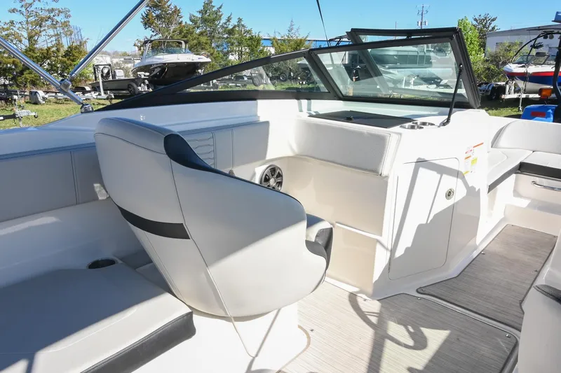 Slide: The Image of 2021 Sea Ray SPX 210 boat interior with sleek seating and modern dashboard design. - 21