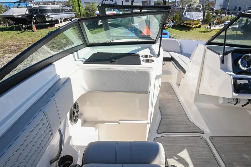 Slide: The Image of 2021 Sea Ray SPX 210 boat interior with seating and dashboard view. - 22
