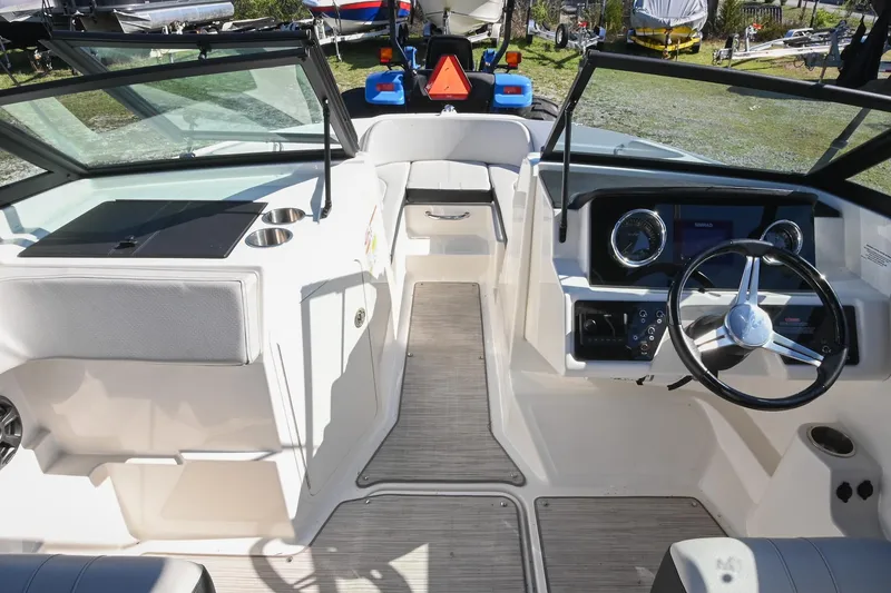 Slide: The Image of 2021 Sea Ray SPX 210 boat interior with steering wheel and dashboard. - 29