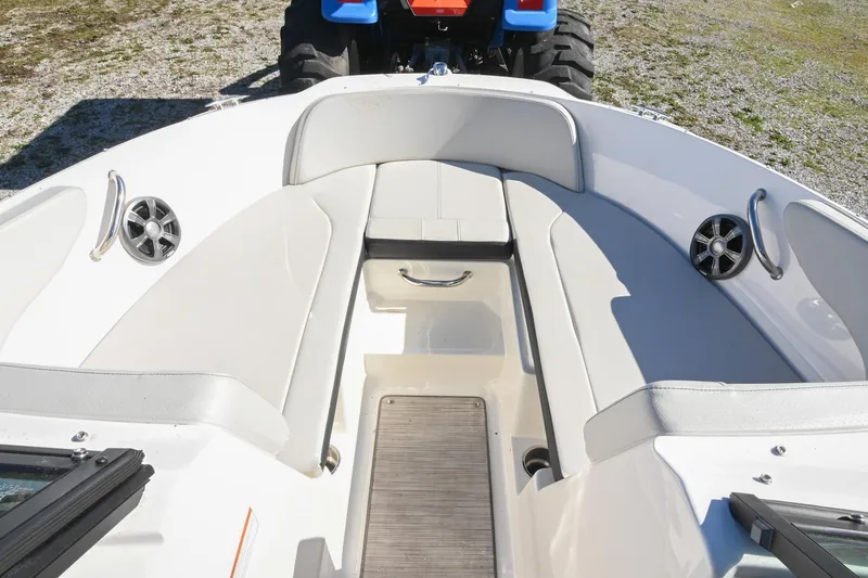 Slide: The Image of 2021 Sea Ray SPX 210 boat interior with cushioned seating and speakers. - 30