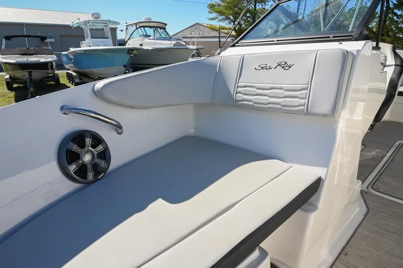 Slide: The Image of 2021 Sea Ray SPX 210 boat interior with cushioned seating and speaker. - 34