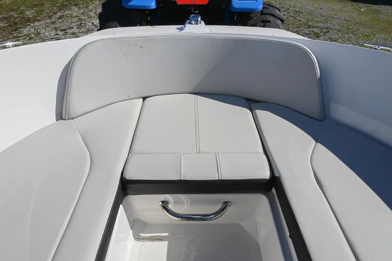 Slide: The Image of 2021 Sea Ray SPX 210 boat interior with cushioned seating and storage compartment. - 35