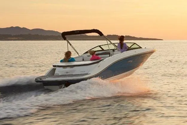 Slide: The Image of 2021 Sea Ray SPX 210 boat on trailer, blue and white design, parked outdoors. - 4