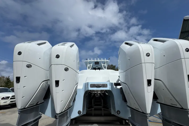 Slide: The Image of 2026 Invincible 46 Catamaran with four powerful outboard engines under a clear blue sky. - 12