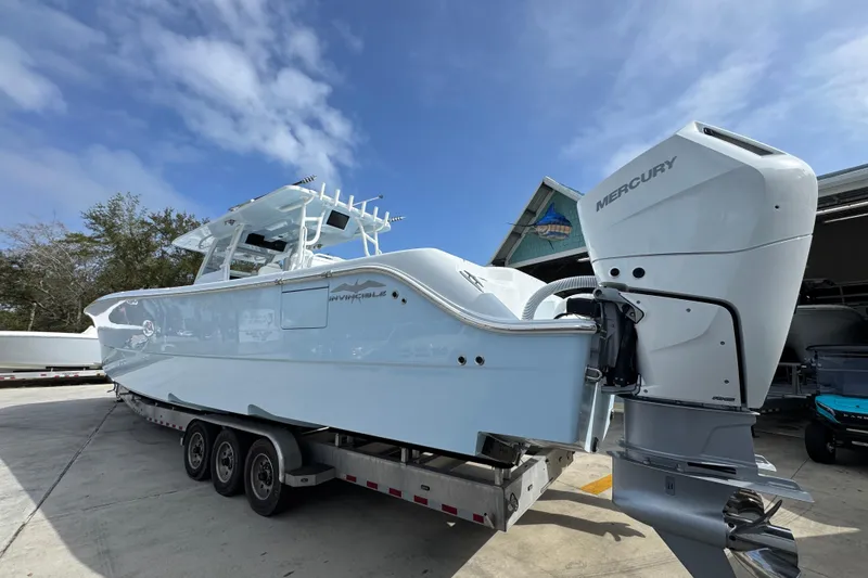 Slide: The Image of 2026 Invincible 46 Catamaran with Mercury outboard engines on a trailer. - 13