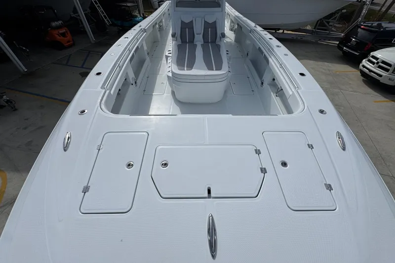 Slide: The Image of 2026 Invincible 46 Catamaran deck view, showcasing spacious seating and storage compartments. - 15