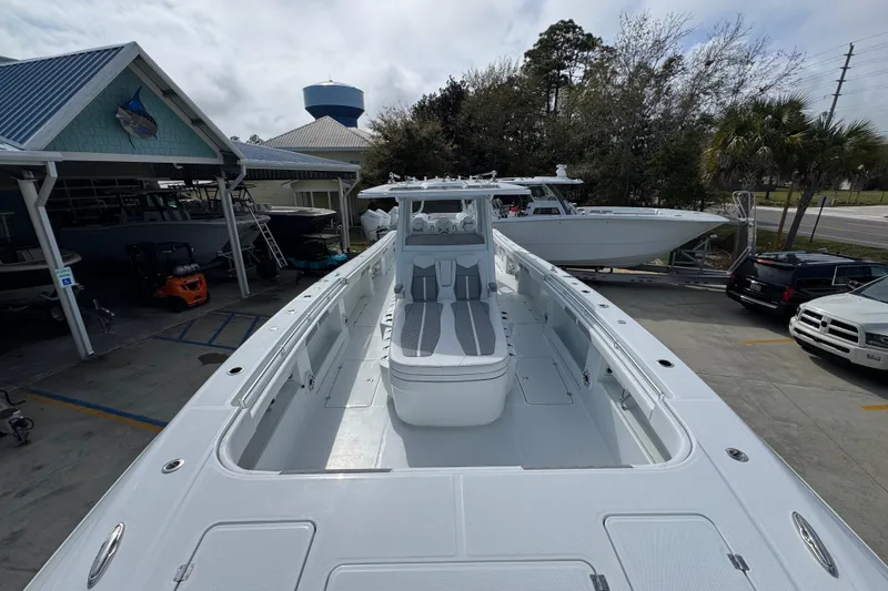 Slide: The Image of 2026 Invincible 46 Catamaran docked, showcasing sleek design and spacious deck layout. - 16