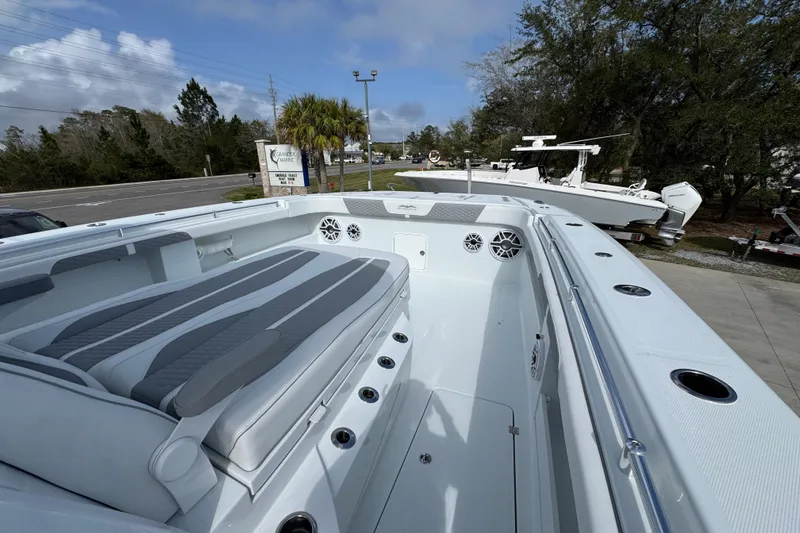 Slide: The Image of 2026 Invincible 46 Catamaran with spacious deck and modern seating, docked outdoors. - 18