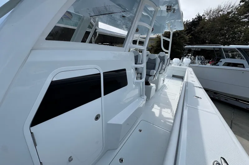 Slide: The Image of 2026 Invincible 46 Catamaran with sleek white deck and modern seating arrangement. - 21