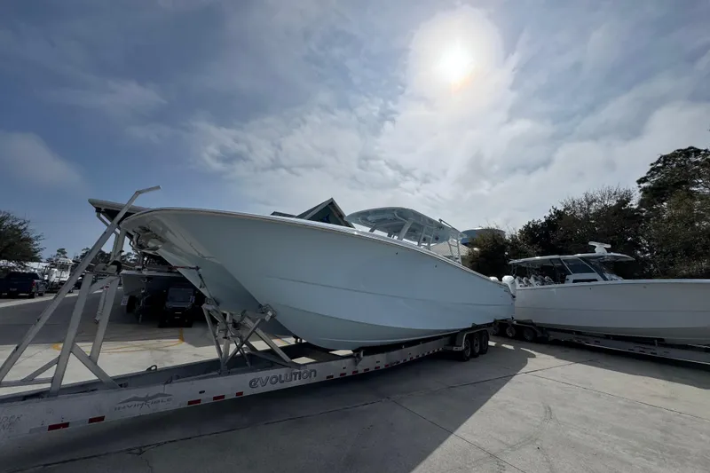 Slide: The Image of 2026 Invincible 46 Catamaran on trailer under cloudy sky, ready for transport. - 3