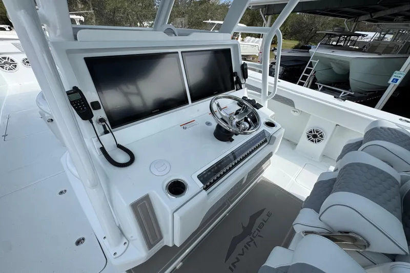 Slide: The Image of 2026 Invincible 46 Catamaran helm with dual screens and modern controls. - 30