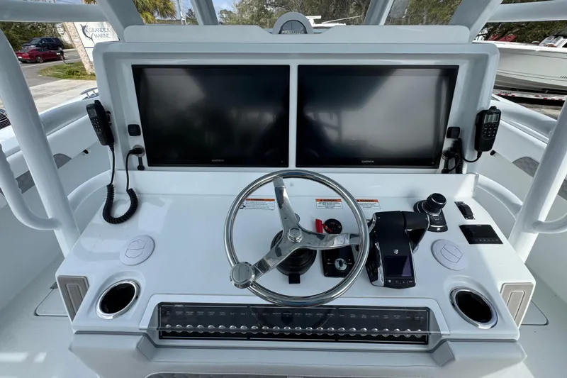 Slide: The Image of Helm of 2026 Invincible 46 Catamaran with dual screens and modern controls. - 31