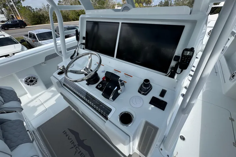 Slide: The Image of Helm of 2026 Invincible 46 Catamaran with dual screens and modern controls. - 34