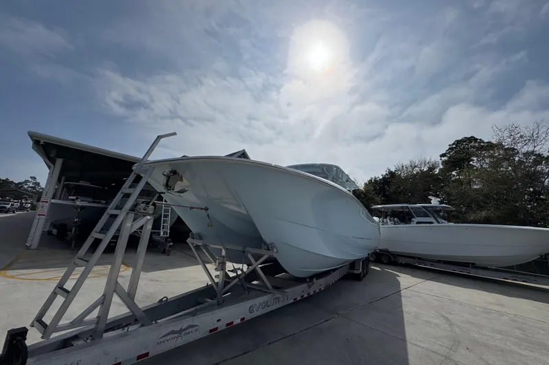 Slide: The Image of 2026 Invincible 46 Catamaran on trailer under cloudy sky, ready for launch. - 4