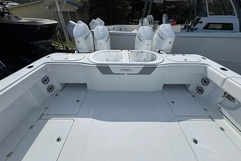 Slide: The Image of 2026 Invincible 46 Catamaran deck with Mercury outboard engines, spacious and modern design. - 40