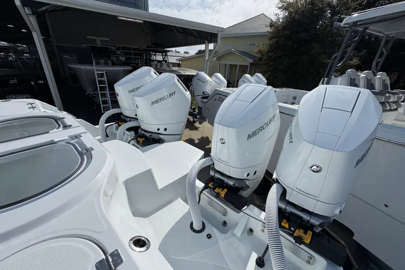 Slide: The Image of 2026 Invincible 46 Catamaran with Mercury outboard engines in a marina setting. - 44