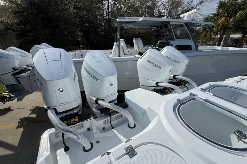 Slide: The Image of 2026 Invincible 46 Catamaran with multiple Mercury outboard engines, docked outdoors. - 45