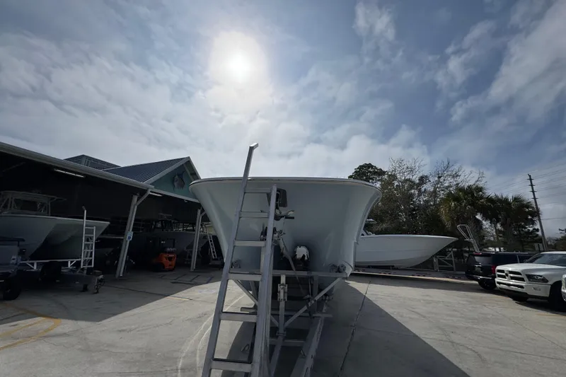 Slide: The Image of 2026 Invincible 46 Catamaran in a boatyard under a cloudy sky. - 5