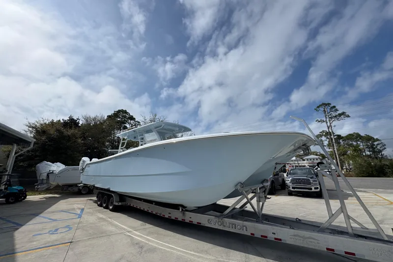 Slide: The Image of 2026 Invincible 46 Catamaran on trailer under cloudy sky, parked in a lot. - 7