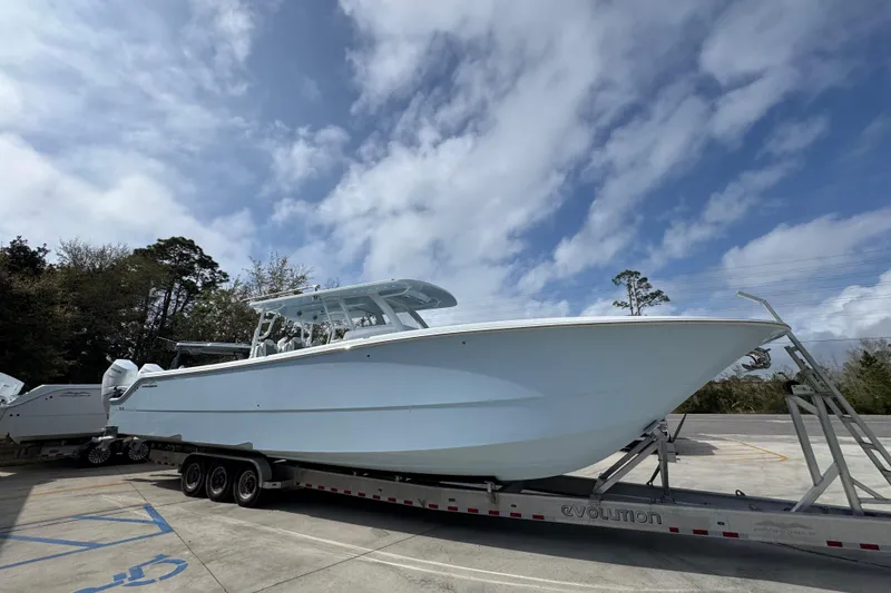 Slide: The Image of 2026 Invincible 46 Catamaran on trailer under cloudy sky. - 8
