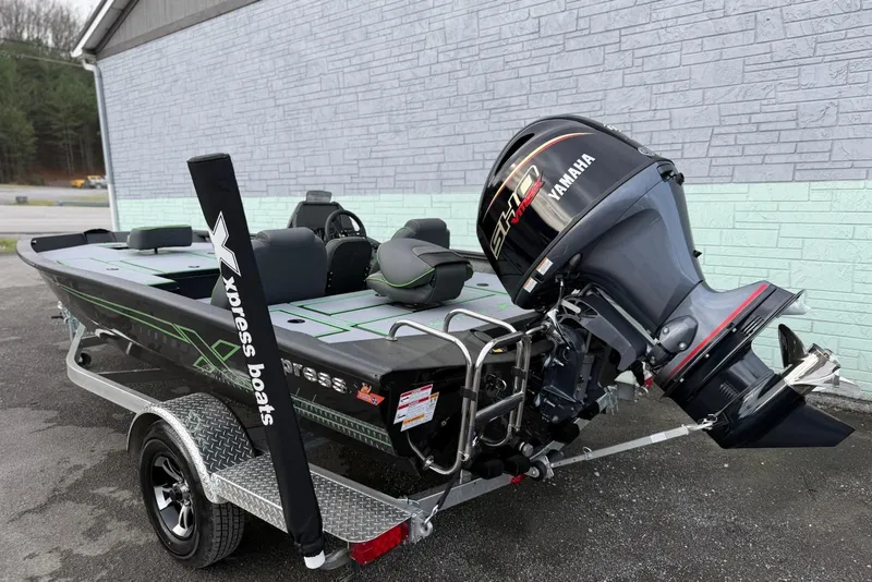 Slide: The Image of 2026 Xpress H18 boat with Yamaha engine on trailer, parked outdoors. - 6