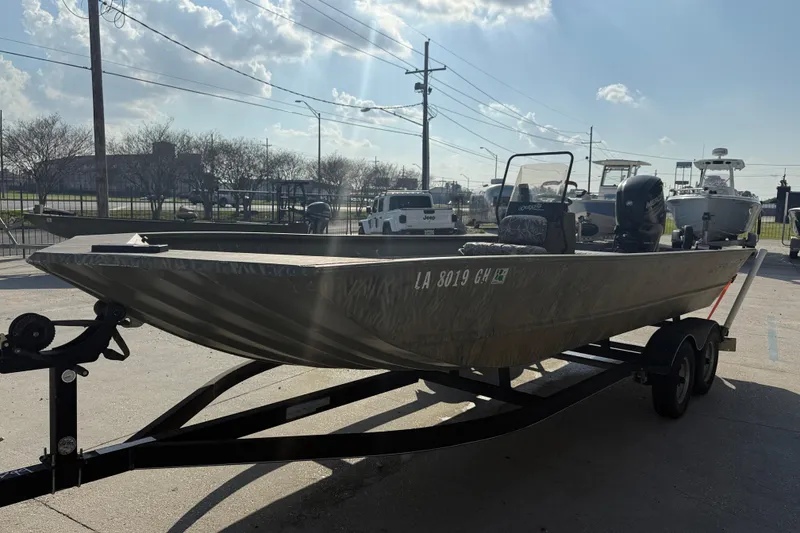 Slide: The Image of 2018 Tracker Grizzly 2072 CC boat on trailer in outdoor setting. - 3