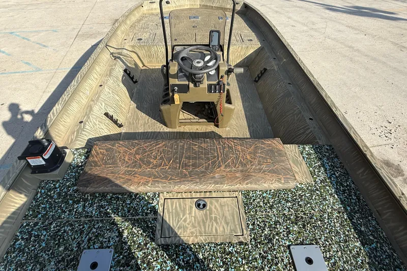 Slide: The Image of 2018 Tracker Grizzly 2072 CC boat interior with camouflage design and steering console. - 7
