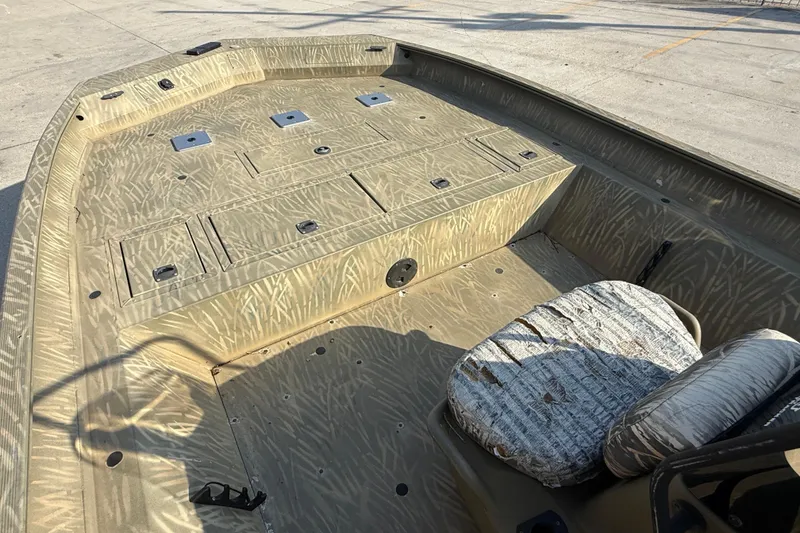 Slide: The Image of 2018 Tracker Grizzly 2072 CC boat interior with camouflage design and seating. - 8