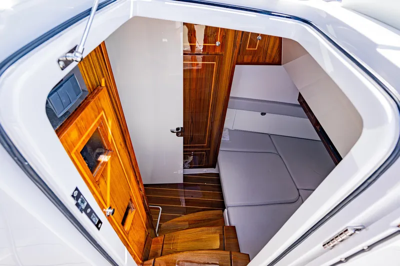 Slide: The Image of 2024 HCB 53 Suenos cabin interior with wood accents and seating area. - 16