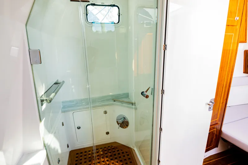 Slide: The Image of Luxurious shower area in 2024 HCB 53 Suenos yacht with glass door and wooden accents. - 18
