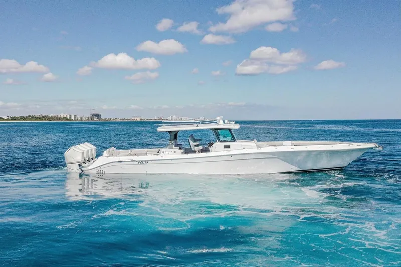 Slide: The Image of 2024 HCB 53 Suenos luxury boat cruising on clear blue ocean waters. - 3