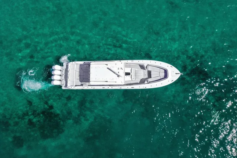 Slide: The Image of Aerial view of 2024 HCB 53 Suenos yacht cruising in clear turquoise waters. - 4