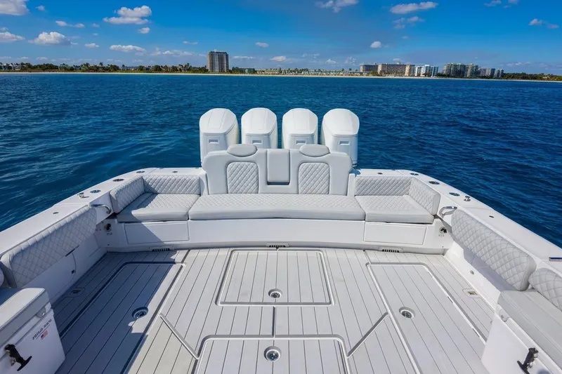 Slide: The Image of 2024 HCB 53 Suenos luxury boat deck with seating, ocean view, and clear sky. - 6