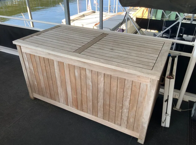 Slide: The Image of Wooden storage box on a Skipperliner 640 houseboat, 2007 model, docked by the water. - 10