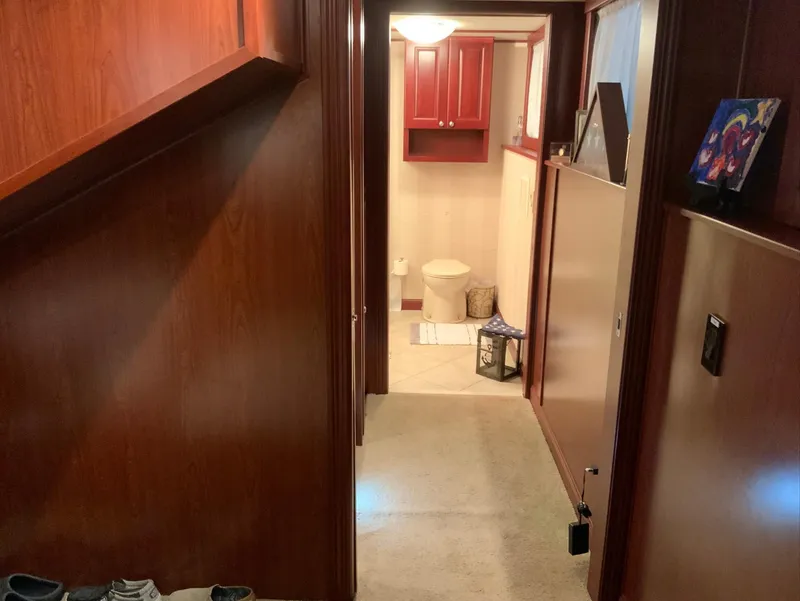 Slide: The Image of Interior hallway of 2007 Skipperliner 640 with wooden paneling and bathroom view. - 48