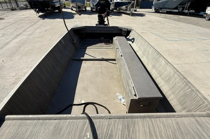 Slide: The Image of 2018 Gator Tail Gator Series 1754 boat interior, empty with bench seat, parked outdoors. - 8