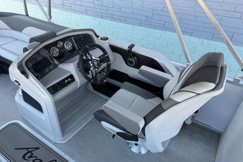 Slide: The Image of 2024 Avalon LSZ Quad Lounge 25' boat interior with modern helm and comfortable seating. - 10