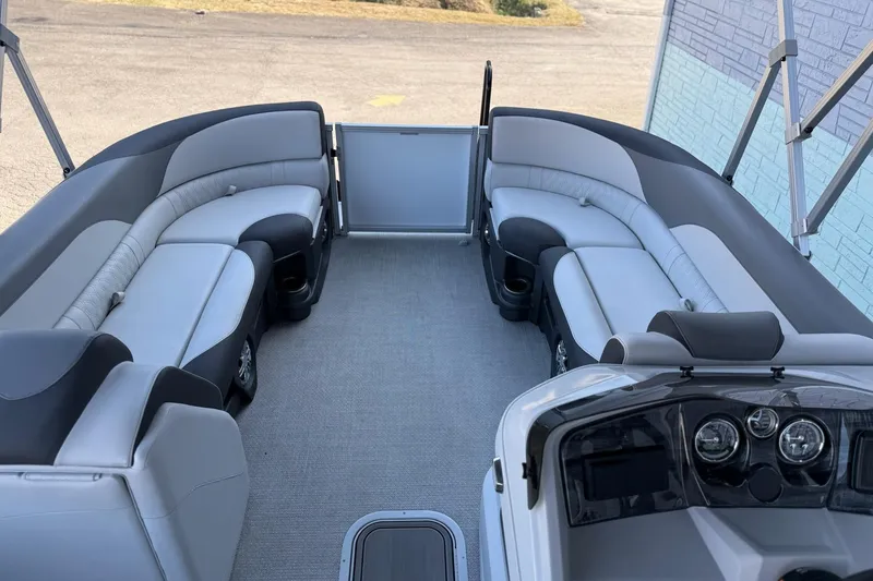 Slide: The Image of 2024 Avalon LSZ Quad Lounge 25' pontoon boat interior with plush seating and modern dashboard. - 9