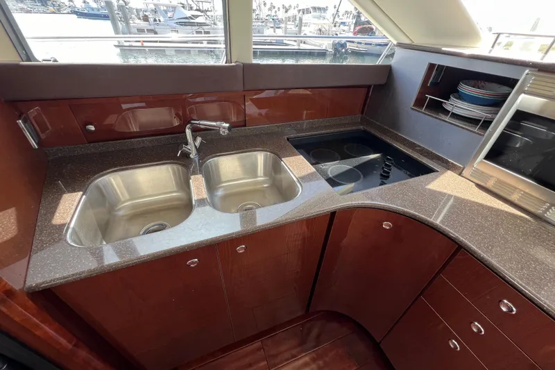 Slide: The Image of Luxurious kitchen in 2013 Meridian 441 Sedan yacht with dual sinks and modern appliances. - 34