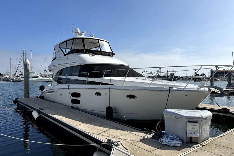 Slide: The Image of 2013 Meridian 441 Sedan yacht docked at marina under clear blue sky. - 4