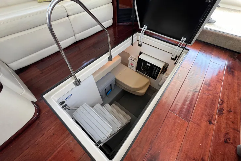 Slide: The Image of 2013 Meridian 441 Sedan interior hatch with stairs and storage, featuring wood flooring. - 49