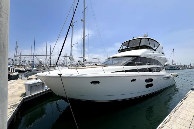 Slide: The Image of 2013 Meridian 441 Sedan yacht docked at marina under clear blue sky. - 5