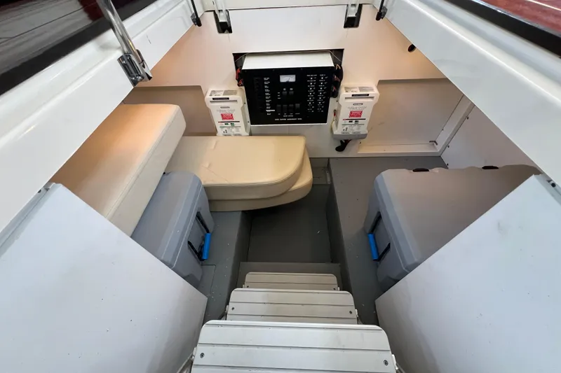 Slide: The Image of Interior of a 2013 Meridian 441 Sedan boat, featuring seating and electrical panel. - 50