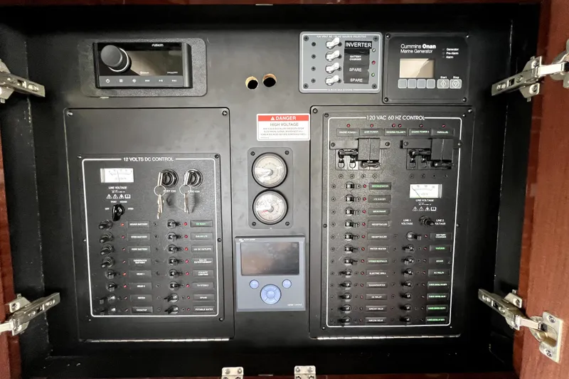Slide: The Image of Electrical control panel of a 2013 Meridian 441 Sedan boat, featuring various switches and gauges. - 58