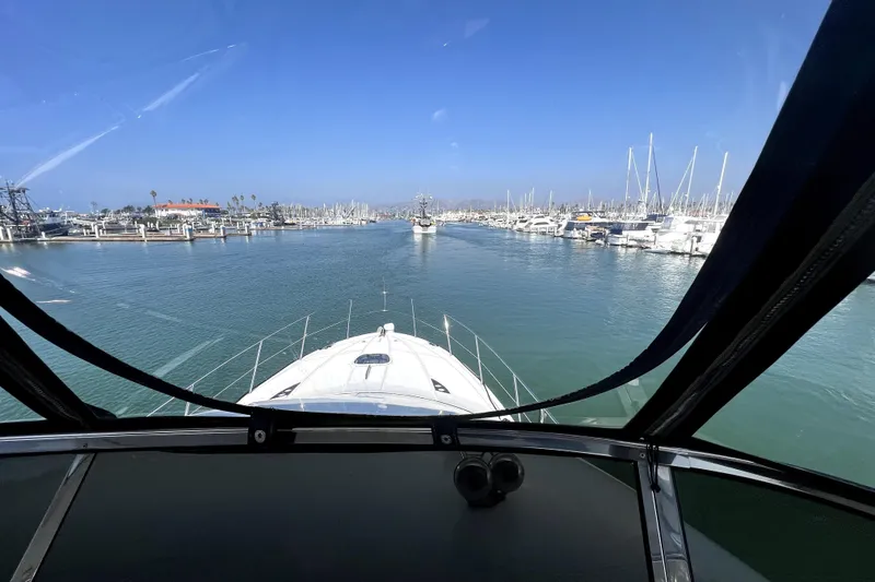 Slide: The Image of View from 2013 Meridian 441 Sedan yacht navigating a marina with clear blue skies. - 6