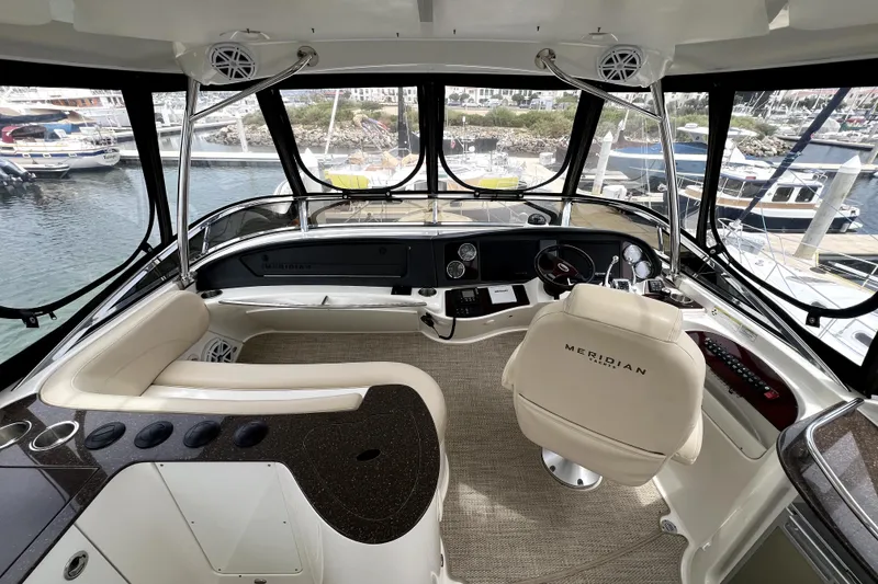 Slide: The Image of Luxurious 2013 Meridian 441 Sedan yacht interior with helm, overlooking marina. - 7
