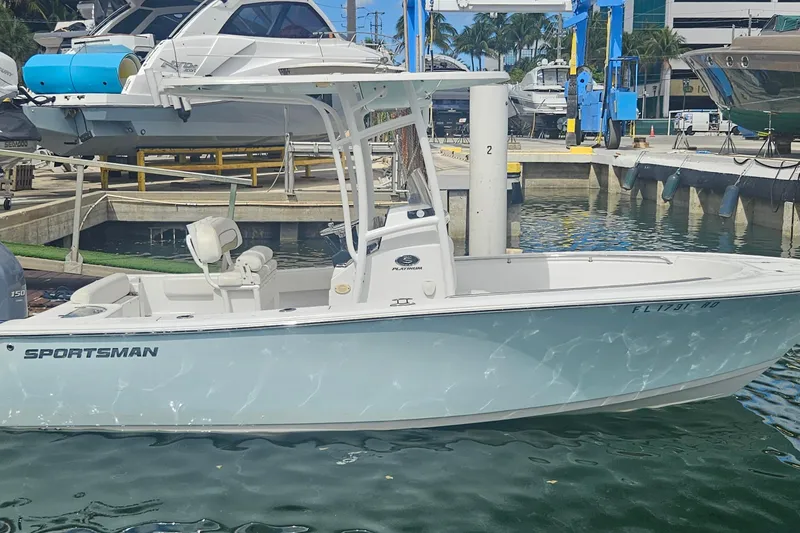 Slide: The Image of 2016 Sportsman Heritage 211 Center Console boat docked at marina. - 1