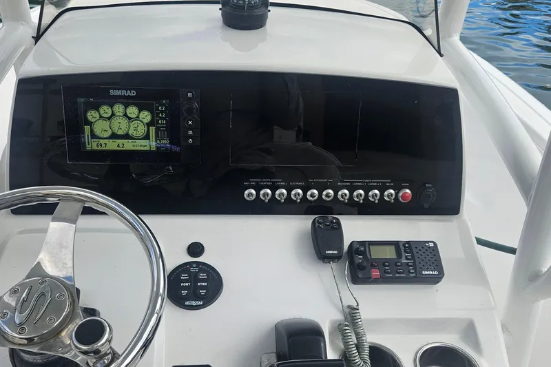 Slide: The Image of 2016 Sportsman Heritage 211 Center Console dashboard with Simrad electronics and steering wheel. - 11