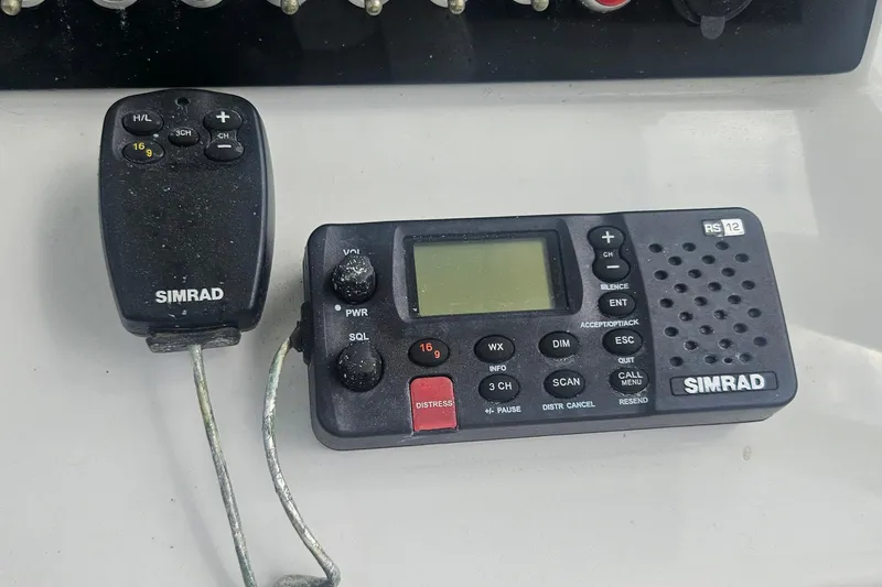 Slide: The Image of Simrad RS12 marine radio and handset on 2016 Sportsman Heritage 211 Center Console. - 14