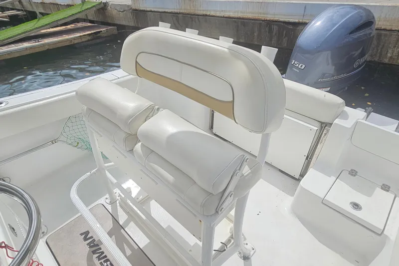 Slide: The Image of 2016 Sportsman Heritage 211 Center Console boat interior with seating and Yamaha 150 engine. - 15